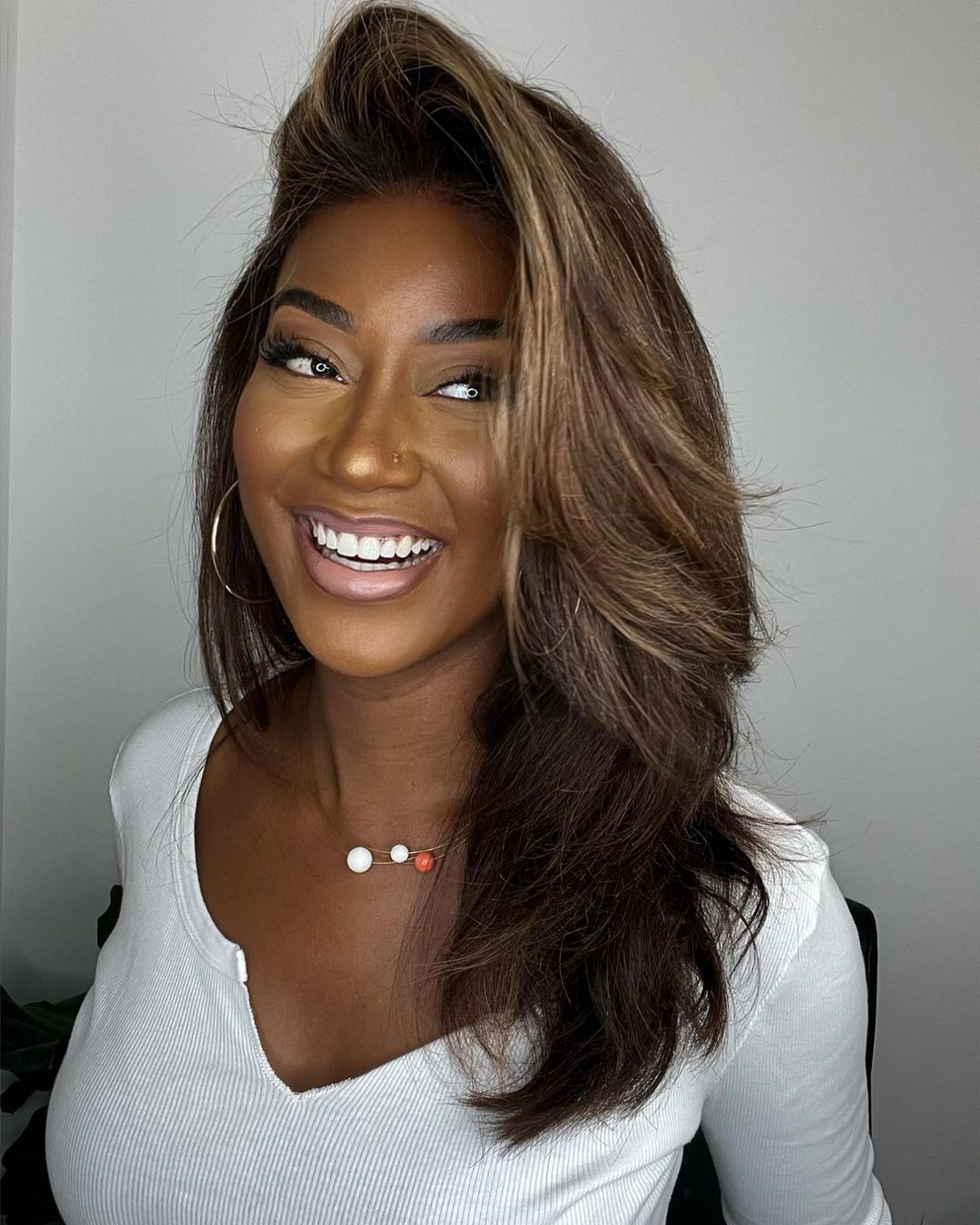 Voluminous wavy human hair lace front wig in dark brown with elegant blonde highlights, perfect for women.