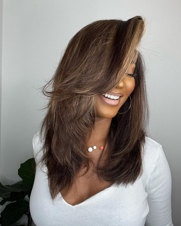 Luxurious dark brown human hair lace front wig with chic blonde highlights. Voluminous wavy style for women.