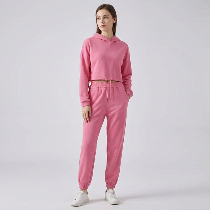 Stylish women's two-piece jogger set with hooded top and high-waisted joggers, ideal loungewear.