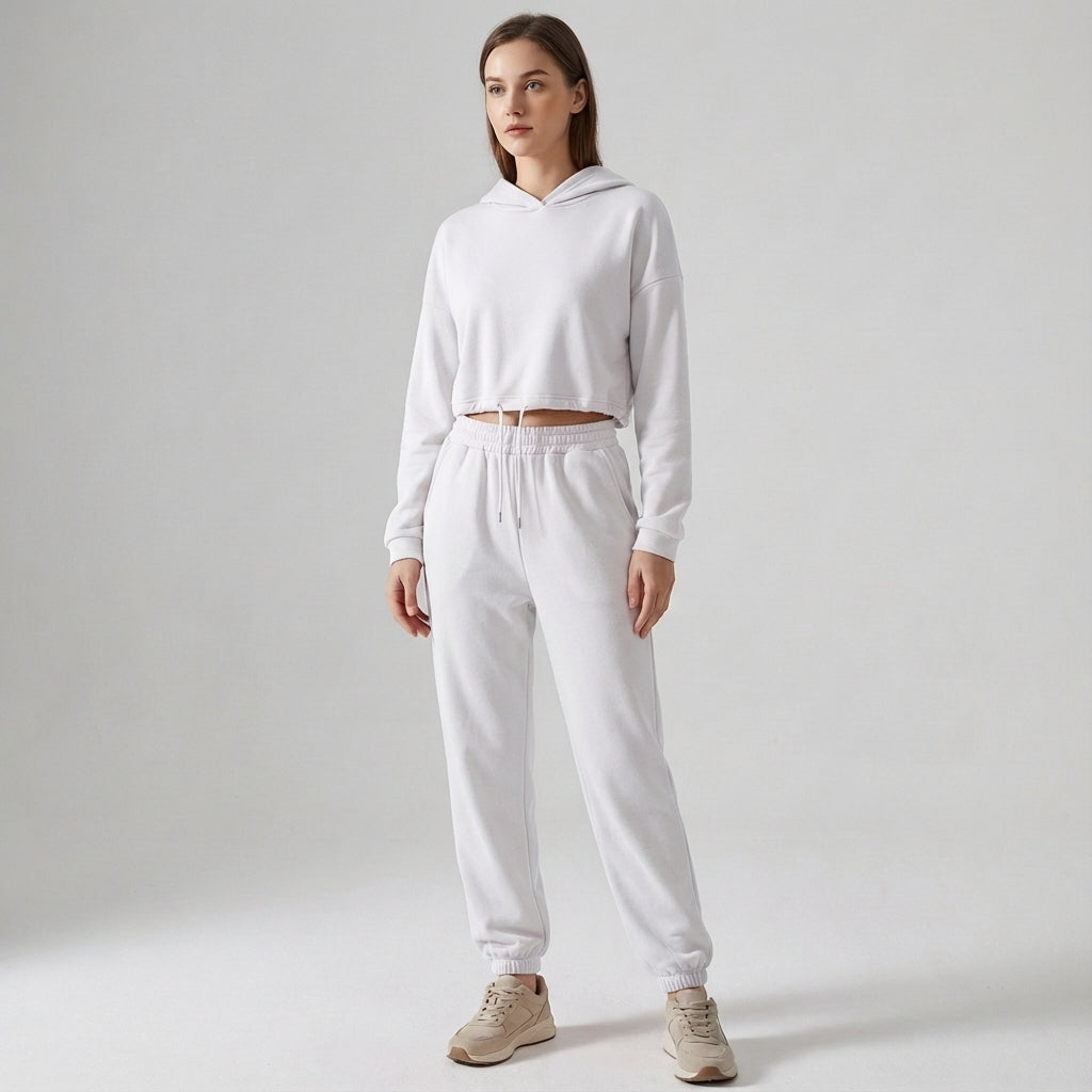 Woman posing in a full-length Katherine hooded jogger tracksuit set, showcasing a relaxed fit.