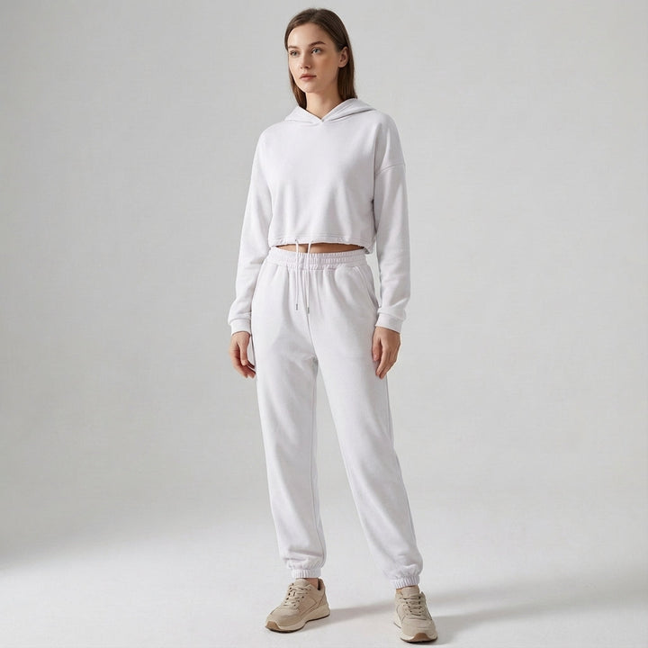 Woman posing in a full-length Katherine hooded jogger tracksuit set, showcasing a relaxed fit.
