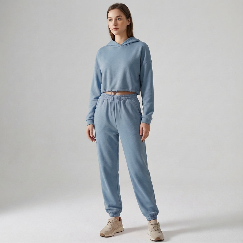 Woman demonstrates flexibility in the comfortable Katherine hooded jogger tracksuit, active wear.