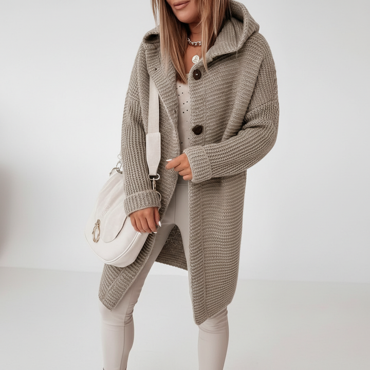 Textured women's hooded knit waistcoat, offering a cozy and chic addition to any wardrobe