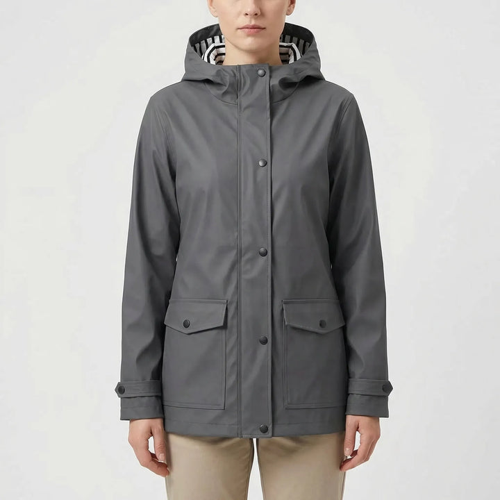 Practical women's waterproof raincoat with adjustable hood. Stay dry in wet weather conditions.