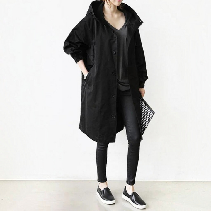 Women's hooded waterproof trench coat, elegant long raincoat for all-season fashion outerwear.