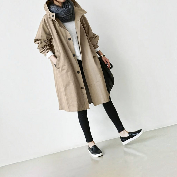 Waterproof hooded women's trench coat, durable elegant long raincoat for all-season outerwear.