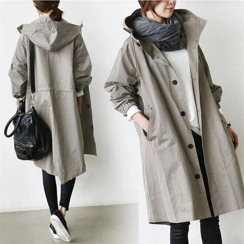 Back view of a women's hooded waterproof trench coat, elegant long all-season fashion raincoat.