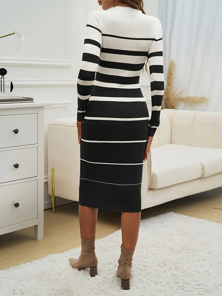 Full length view of a woman wearing the flattering Horizon Stripe bodycon midi dress, long sleeve style.
