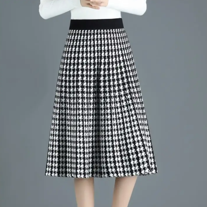 Elegant women's pleated midi skirt in houndstooth pattern. High-waist A-line style, ideal for winter & office wear.