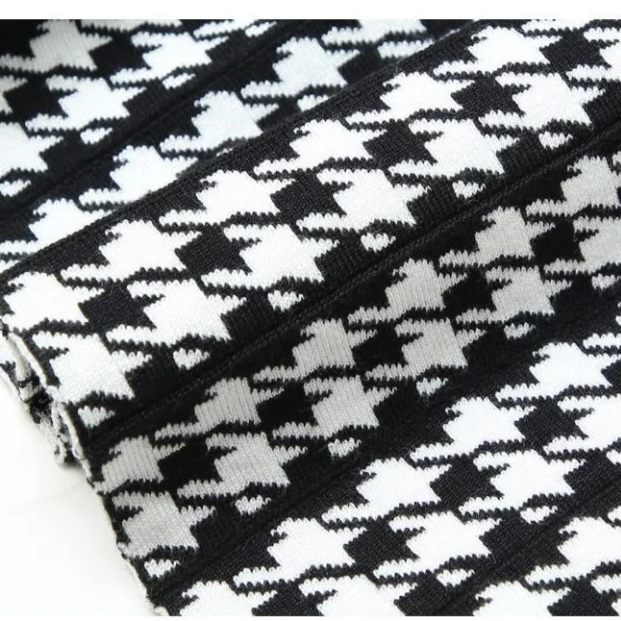 Fashionable women's houndstooth midi skirt, A-line & pleated. High-waist with stretch, versatile for fall & office style.