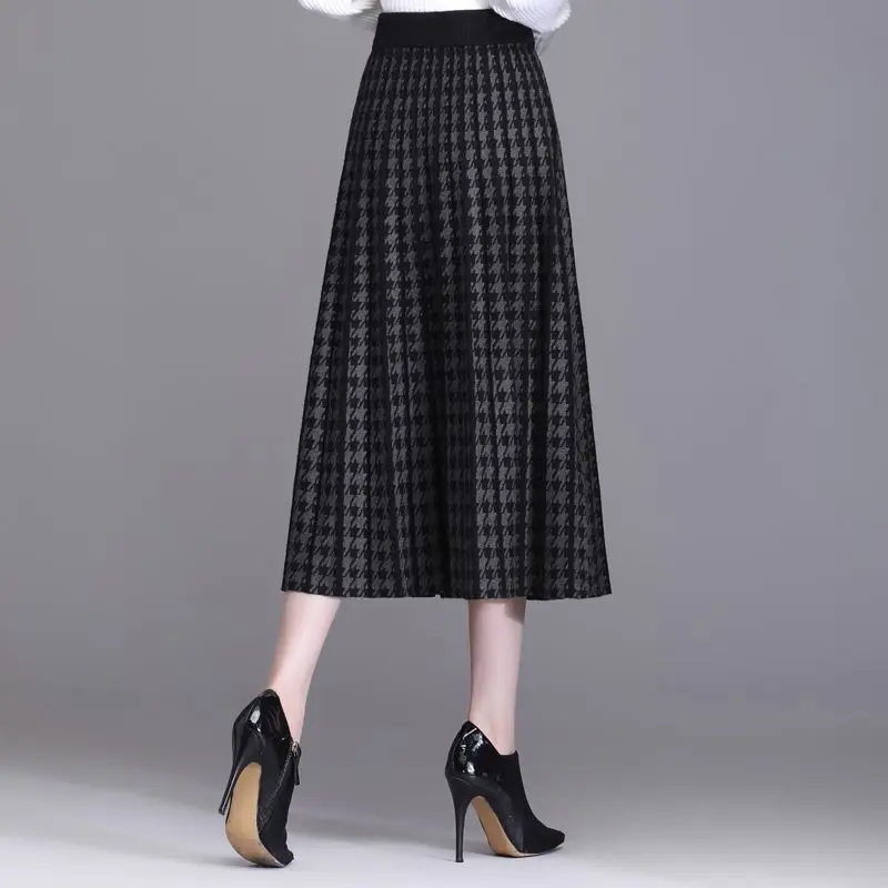 Classic houndstooth pleated midi skirt for women, high-waist A-line. Elegant and chic for office wear, fall & winter fashion.