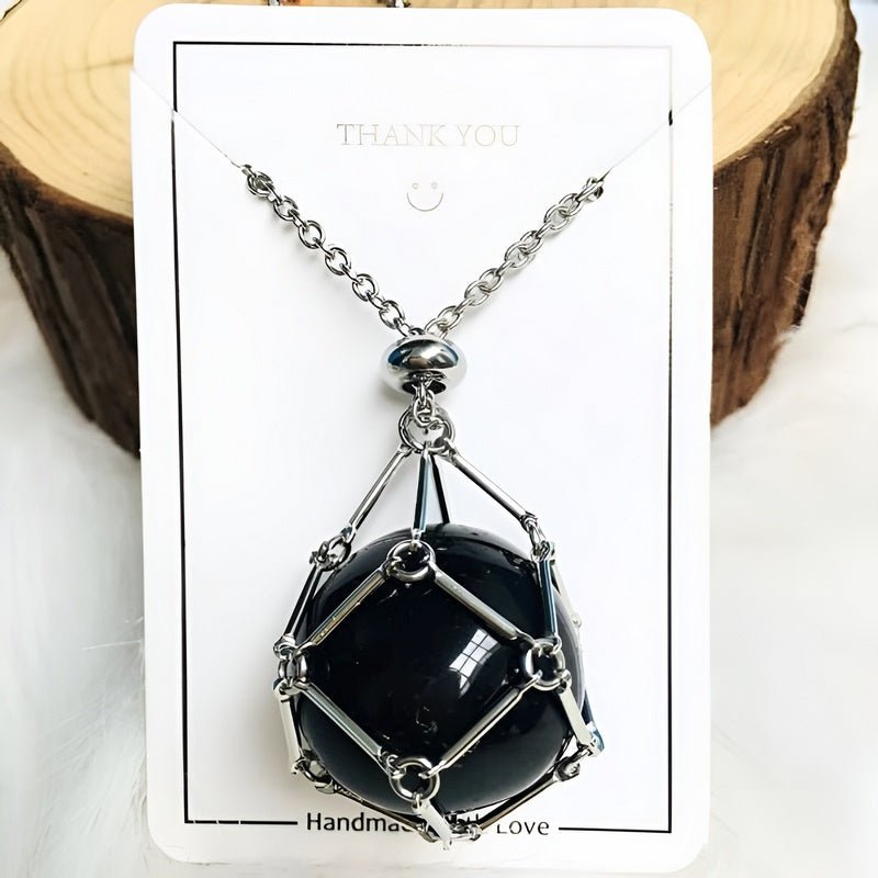 Woman wearing a crystal holder necklace with an interchangeable gemstone pendant. Elegant spiritual jewelry.