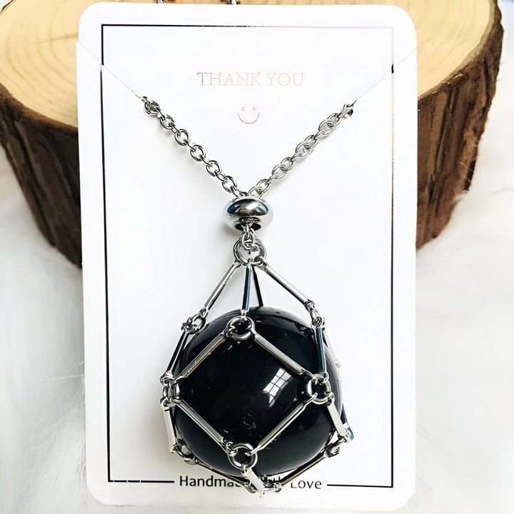 Woman wearing a crystal holder necklace with an interchangeable gemstone pendant. Elegant spiritual jewelry.