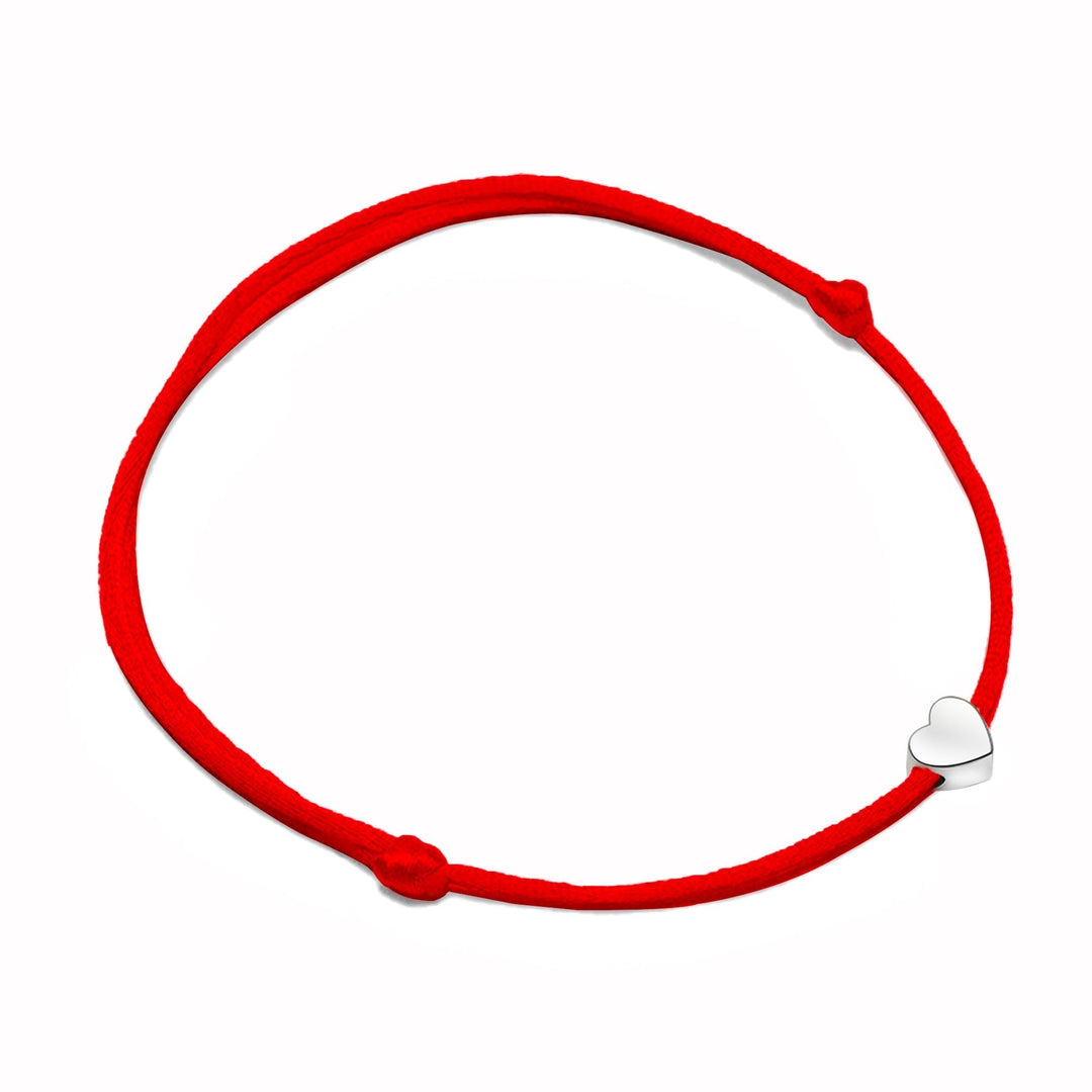 Close-up of a silver adjustable bracelet for women featuring a delicate heart charm