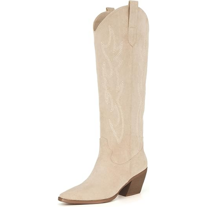 Outdoor shot of women's knee-high cowboy boots, highlighting embroidered patterns and robust heel
