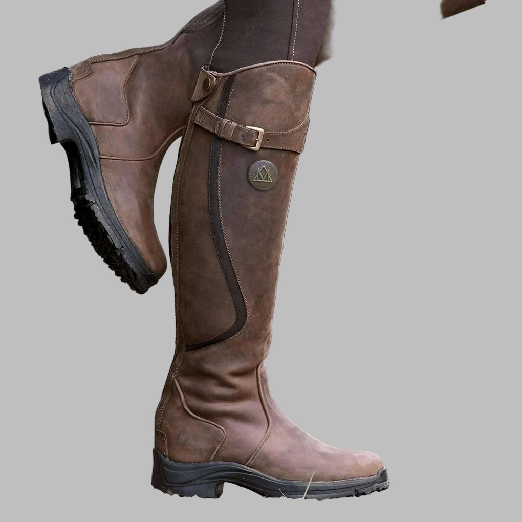 Women's knee-length buckled hiking boots in brown, perfect for fall outdoor adventures & comfortable walks.