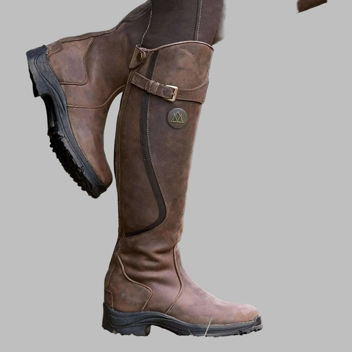 Women's knee-length buckled hiking boots in brown, perfect for fall outdoor adventures & comfortable walks.