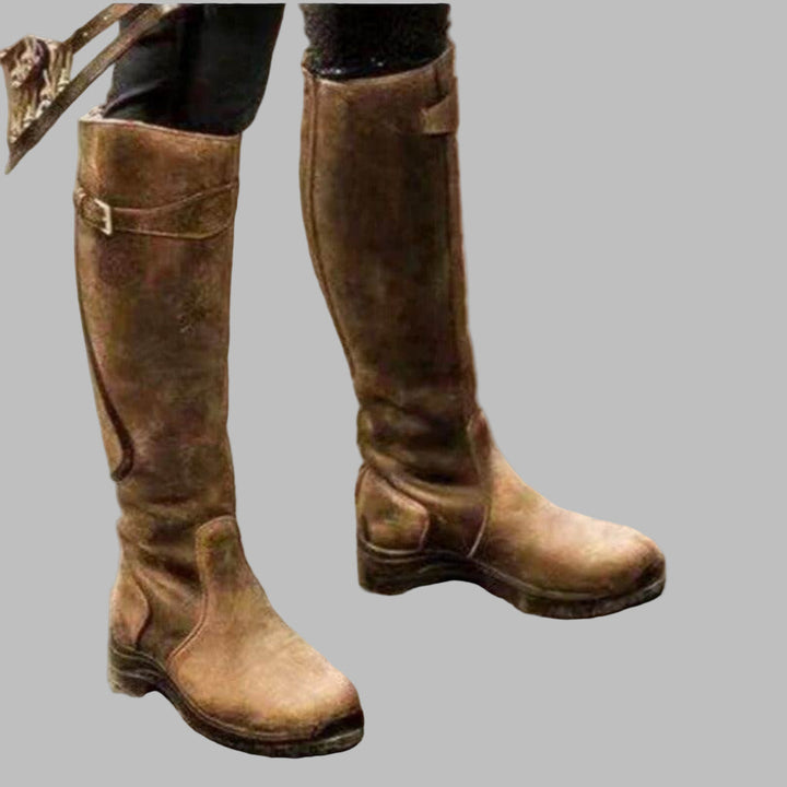 Comfortable women's knee-length walking boots with buckled straps, ideal for hiking & casual outdoor wear.