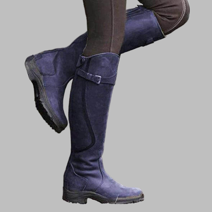 Black women's buckled knee-length hiking boots, durable & supportive for all-weather outdoor adventures.