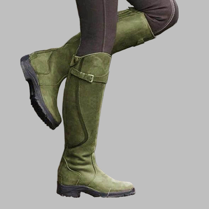 Rugged women's knee-high buckled boots, essential durable footwear for hiking, fall, and casual outings.