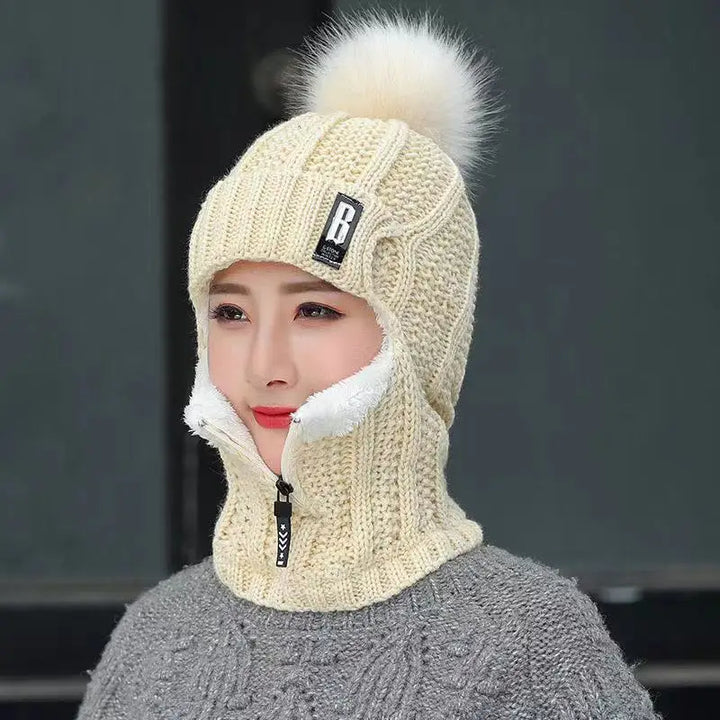 Women's knitted balaclava with fluffy pompom, perfect for warm and stylish winter wear in cold weather.