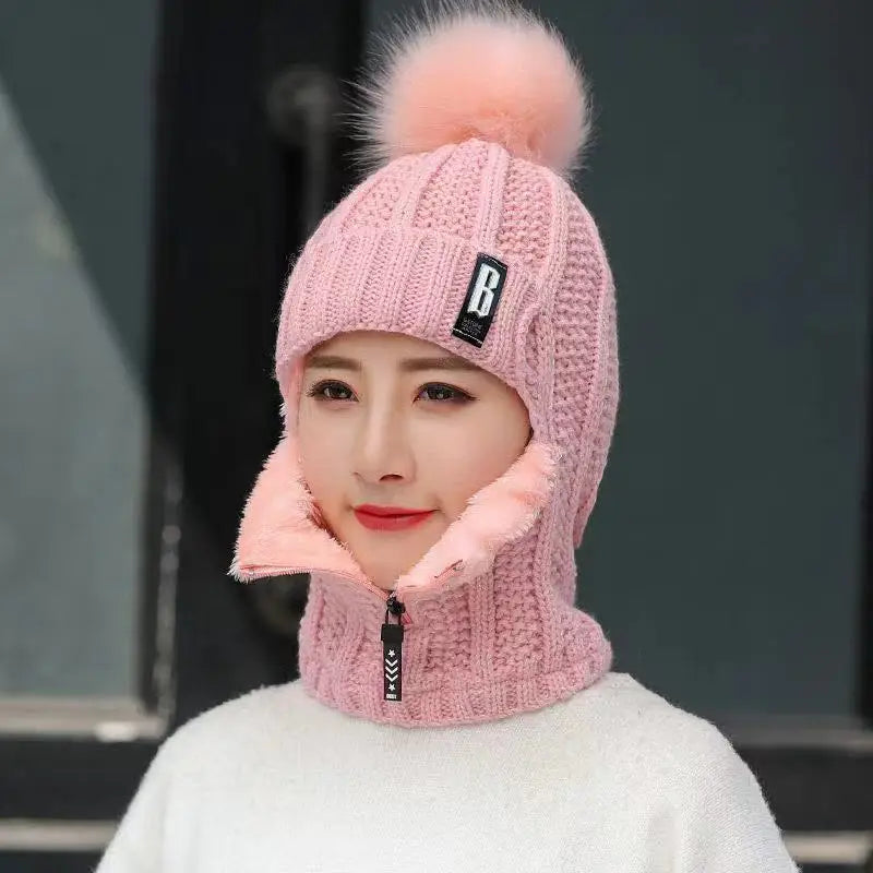 Stylish women's knitted balaclava featuring a chic design and playful pompom, essential for trendy winter fashion.