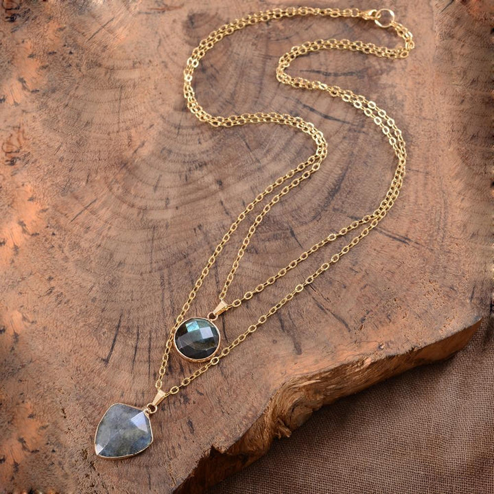 Close-up of a shimmering labradorite protection pendant on a delicate chain, a spiritual energy necklace for women.