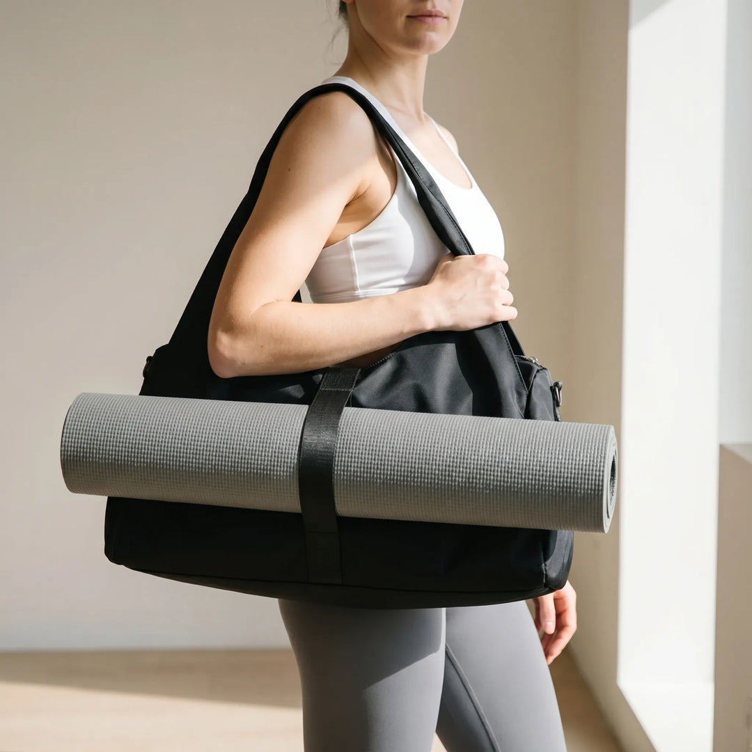 Women's large capacity gym duffel bag in black, ideal for activewear, sports, and fitness gear. Perfect for gym or yoga.
