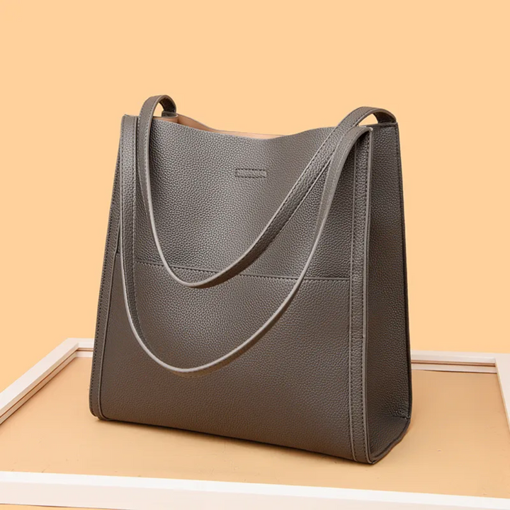 Elegant black leather tote handbag for women, a spacious and stylish purse for daily essentials.