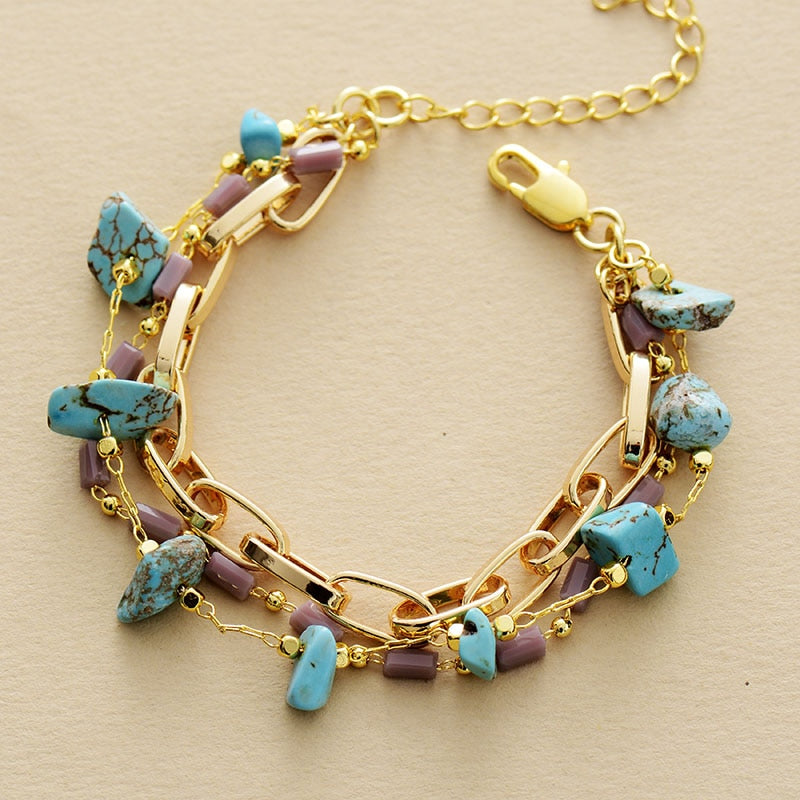 Women's layered bracelet with turquoise and opal gemstones, an elegant handcrafted fashion accessory.