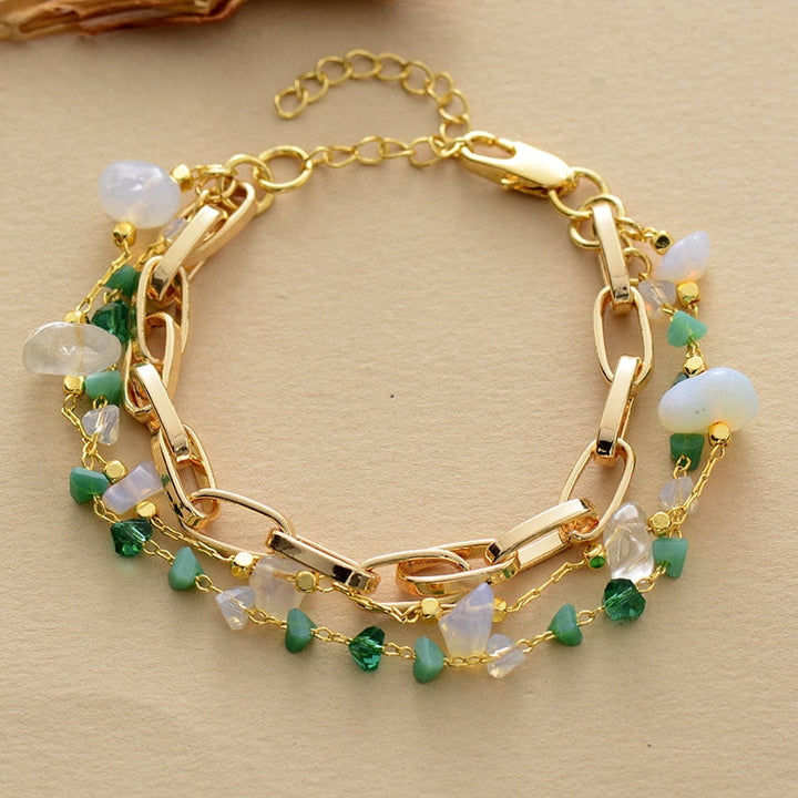 Handcrafted women's layered bracelet showcasing vibrant turquoise and iridescent opal gemstones.