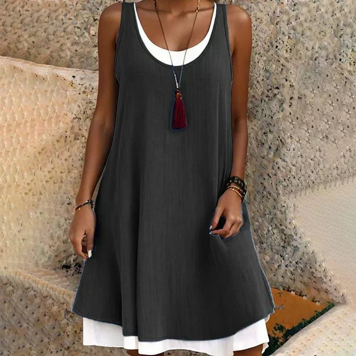 Women's layered mini dress with a sleeveless scoop neck, perfect for summer casual wear or travel.