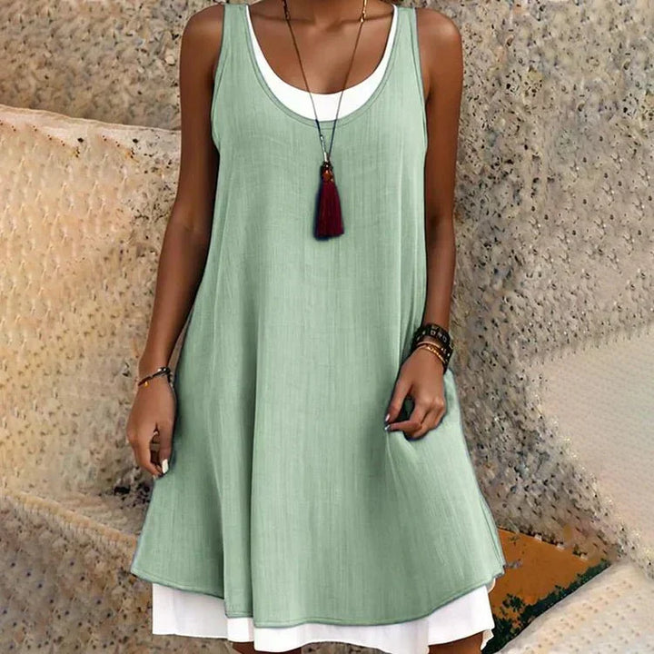 Comfortable women's sleeveless layered mini dress with a flattering scoop neck, ideal for warm weather and travel.