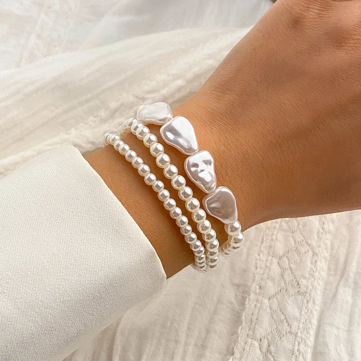 Women's layered pearl bracelet featuring delicate freshwater pearls on a stainless steel chain. Elegant & adjustable.