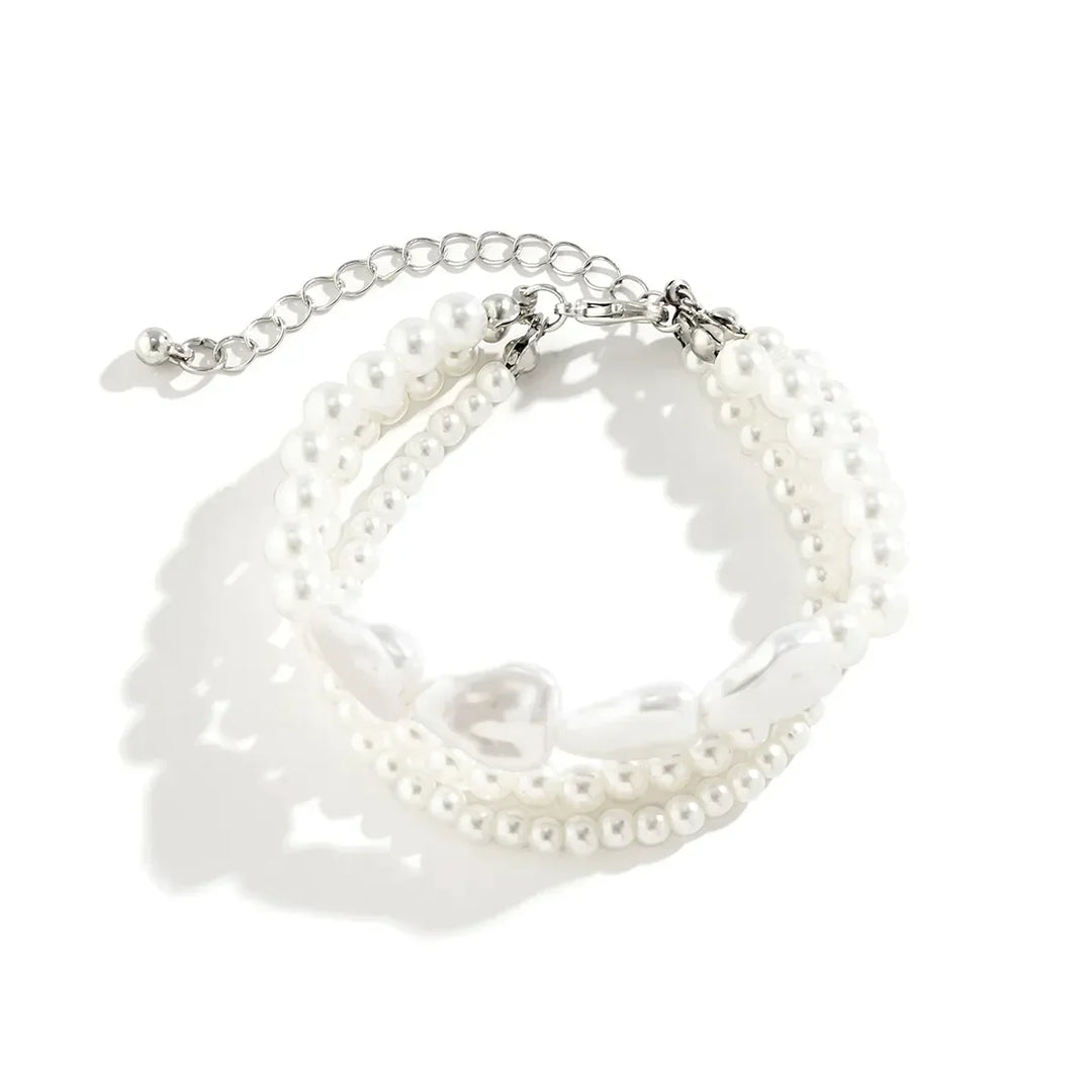 Elegant women's layered bracelet with lustrous freshwater pearls and durable stainless steel; a delicate jewelry piece.