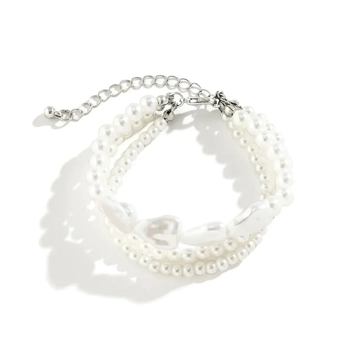 Elegant women's layered bracelet with lustrous freshwater pearls and durable stainless steel; a delicate jewelry piece.