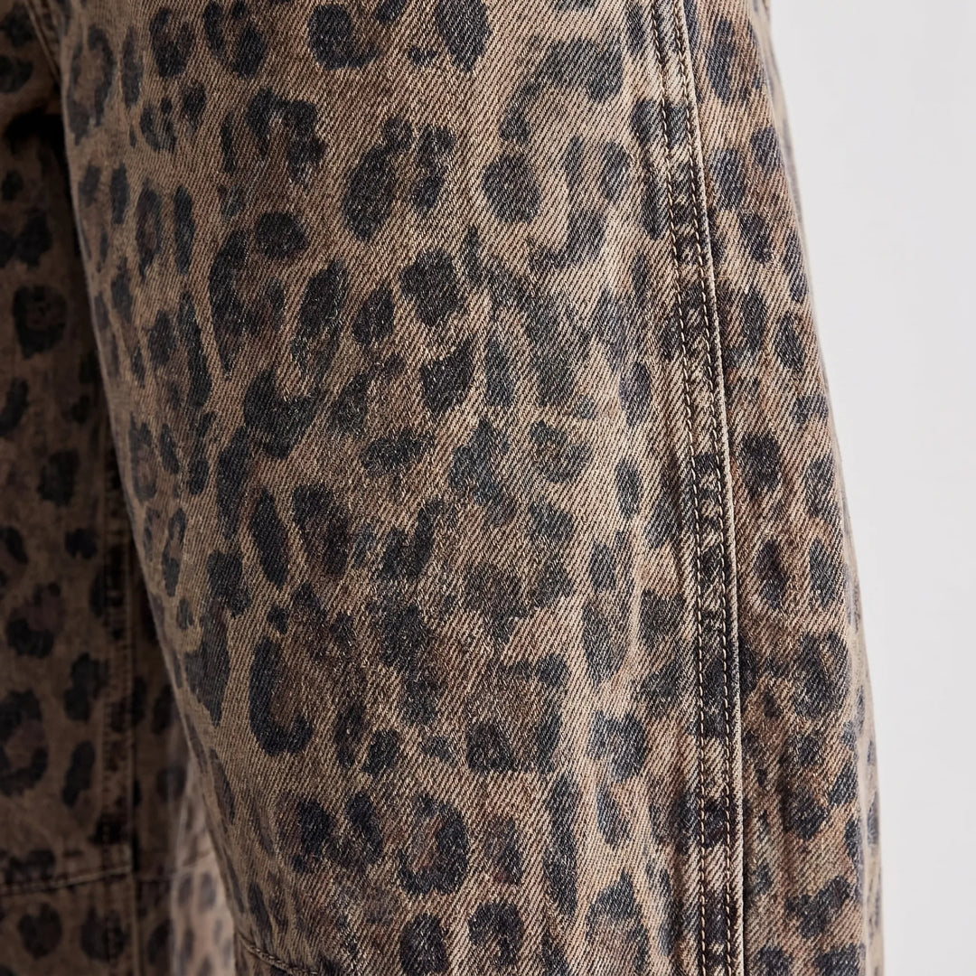 Trendy women's leopard print barrel jeans, relaxed mid-rise, ankle-length, ideal for streetwear fashion.