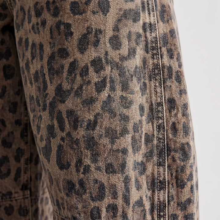 Trendy women's leopard print barrel jeans, relaxed mid-rise, ankle-length, ideal for streetwear fashion.