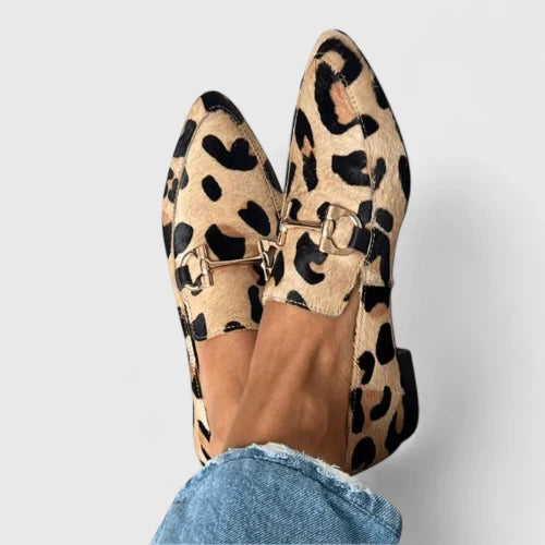 Women's leopard print flat loafers with pointed toe, slip-on design, & elegant gold horsebit detail. Comfortable & stylish.