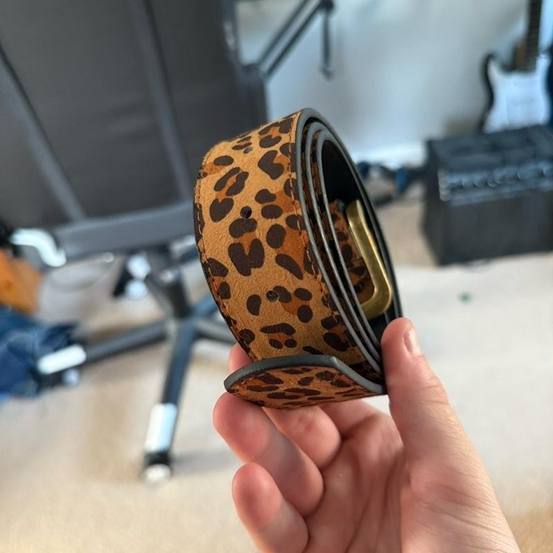 Stylish women's adjustable suede belt featuring a bold leopard print, perfect for any outfit.