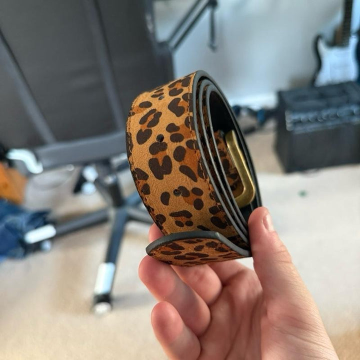Stylish women's adjustable suede belt featuring a bold leopard print, perfect for any outfit.
