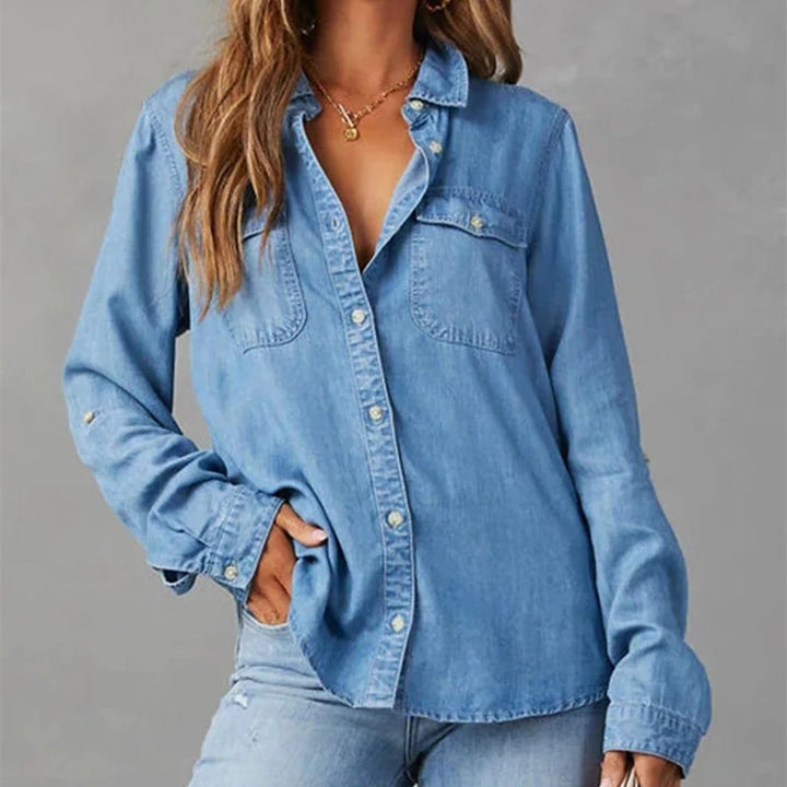 Relaxed fit women's light blue denim button-down shirt, ideal casual top for versatile everyday wear.