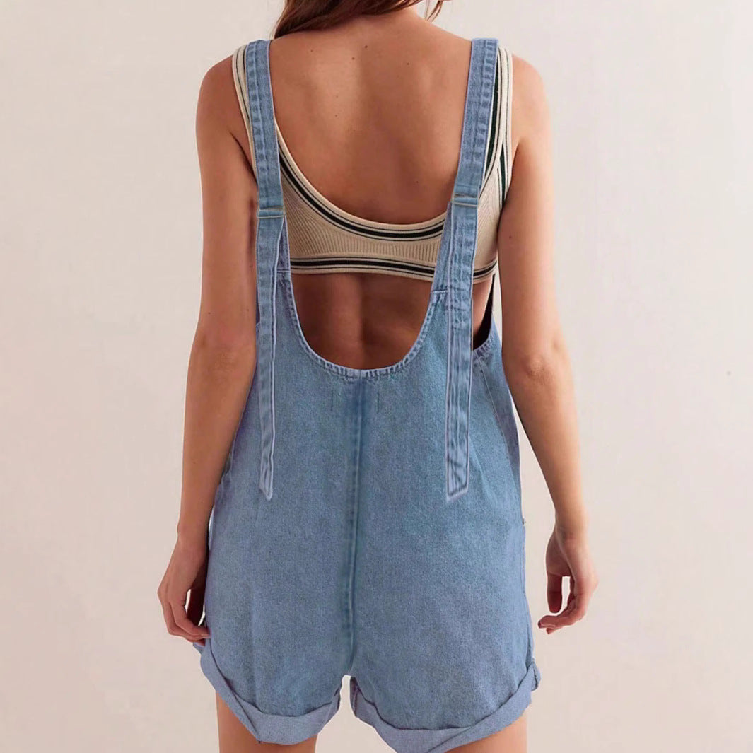 Dark blue sleeveless denim romper for women, featuring a comfortable relaxed fit and practical pockets.