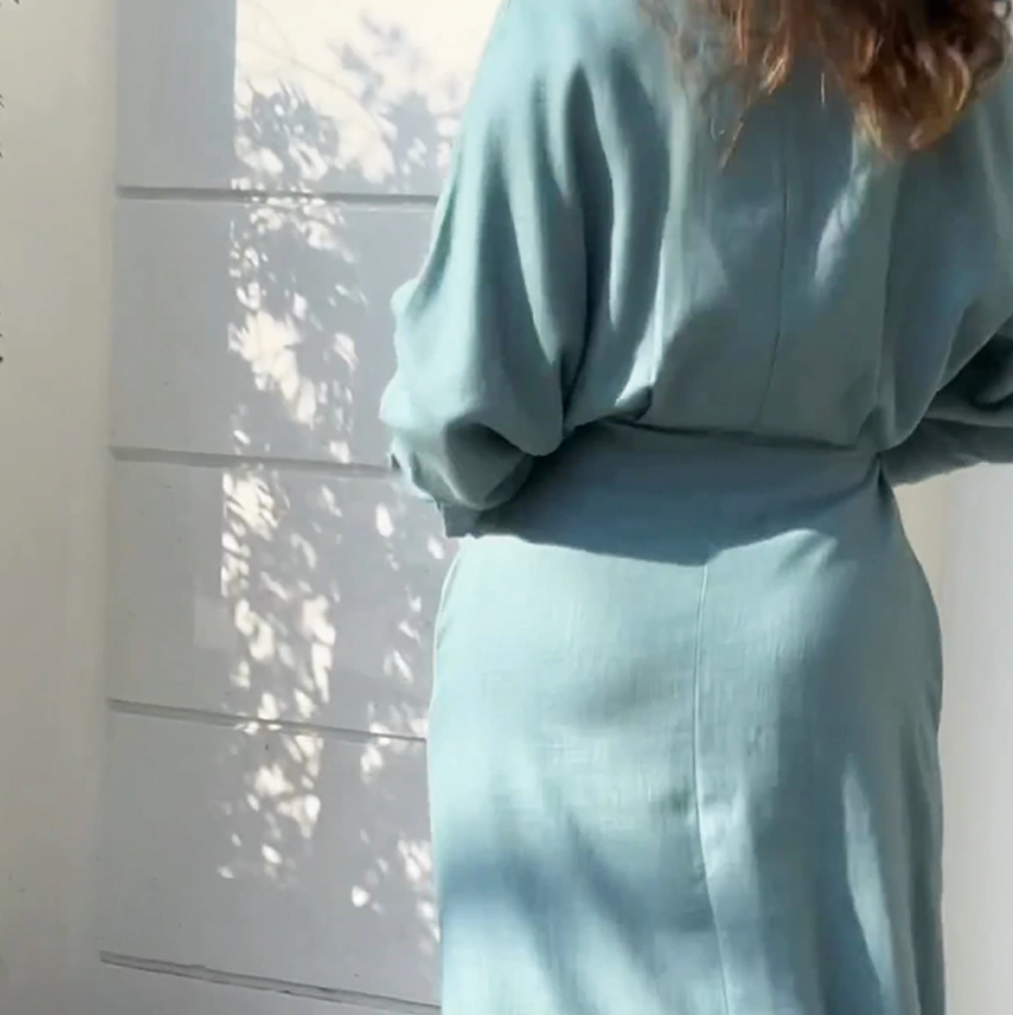 Feminine light blue long-sleeve summer dress with a chic waist tie, perfect for women seeking a stylish casual or party look.