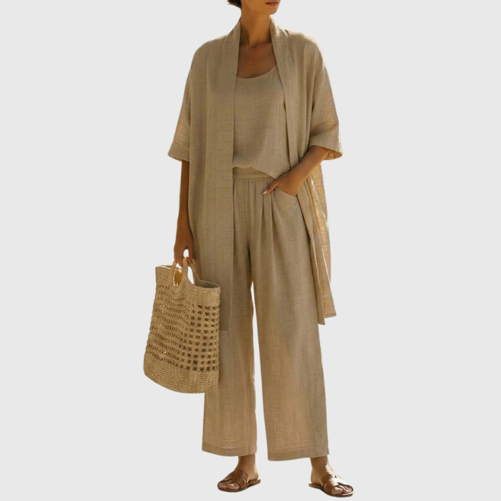 Woman in elegant women's three-piece resort wear set. Soft, airy, coordinated summer fashion for travel.