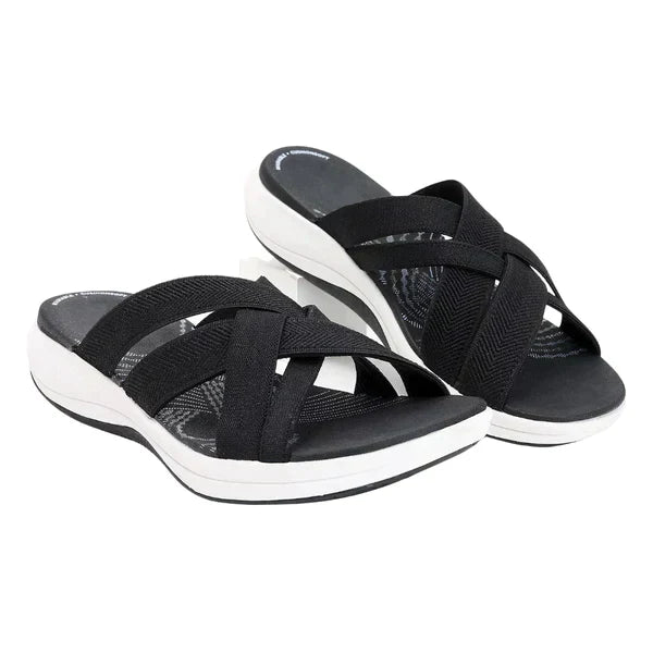 Orthopedic women's slippers featuring shock-absorbing footbed, arch support, & lightweight design for comfort.