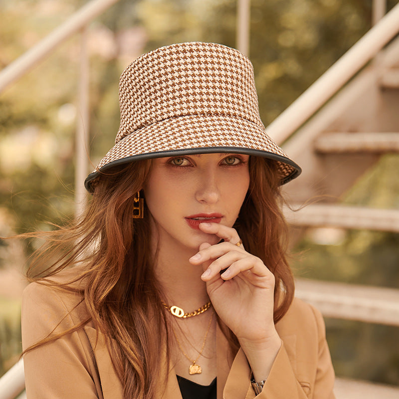 Stylish women's black fabric bucket hat, a versatile summer accessory for sun and fashion.