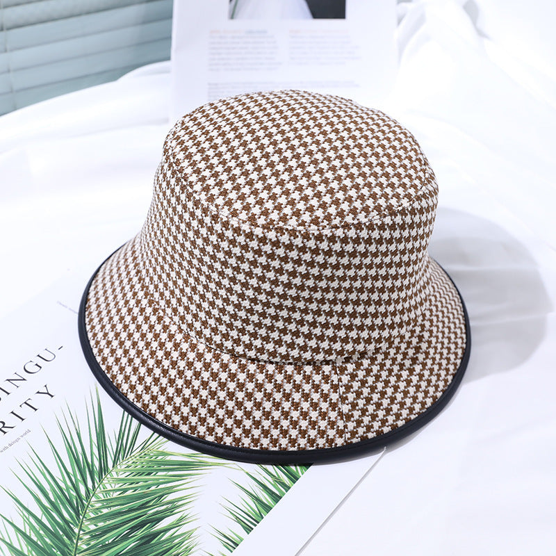 Casual women's coffee fabric bucket hat, offering sun protection and summer fashion appeal.