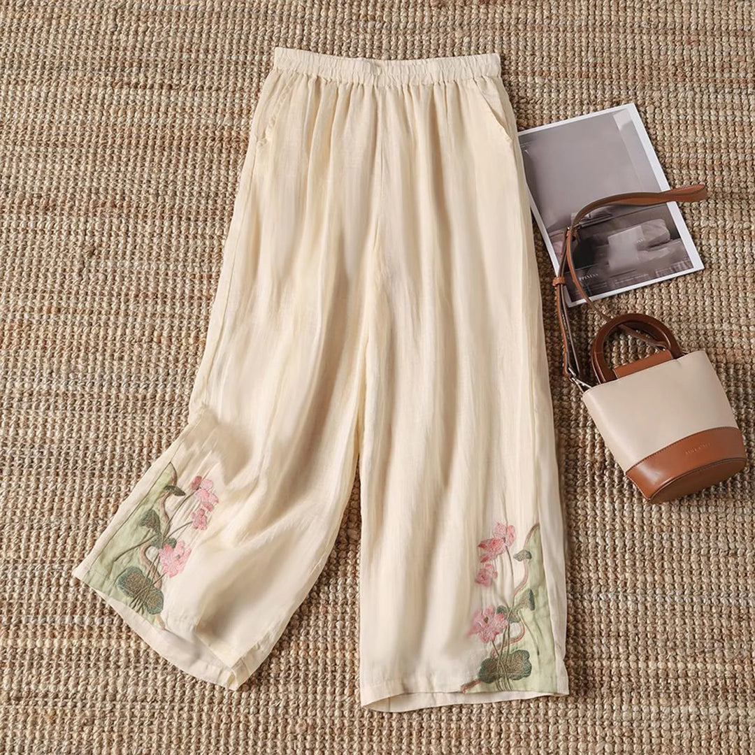 Vibrant floral print on comfortable cotton blend women's summer trousers, ideal for stylish casual wear.