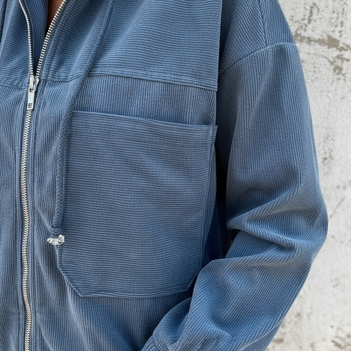 Close-up of a Regina women's lightweight polyester jacket in grey, showing zipper detail & hood